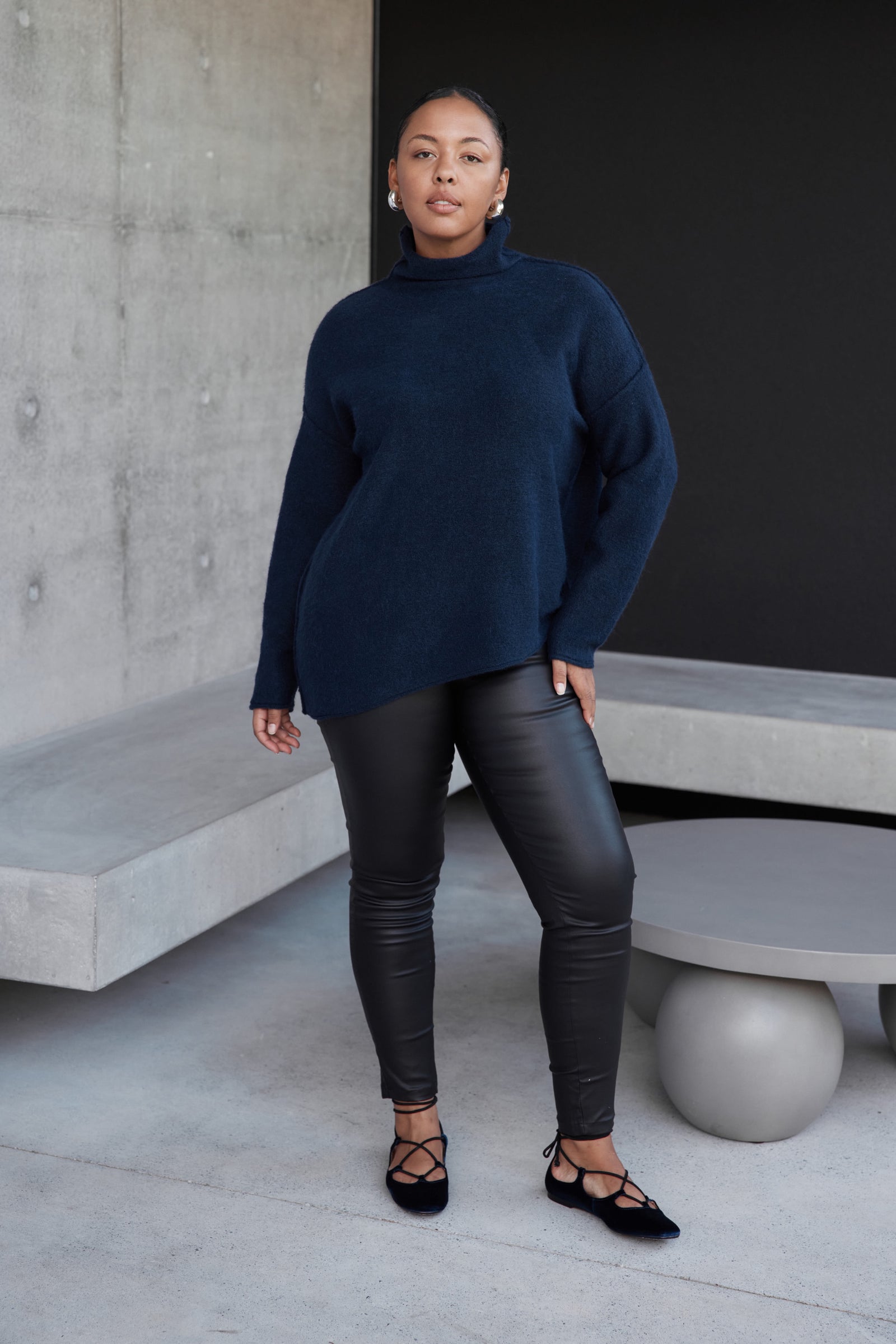 EXPOSED SEAM FUNNEL NECK KNIT